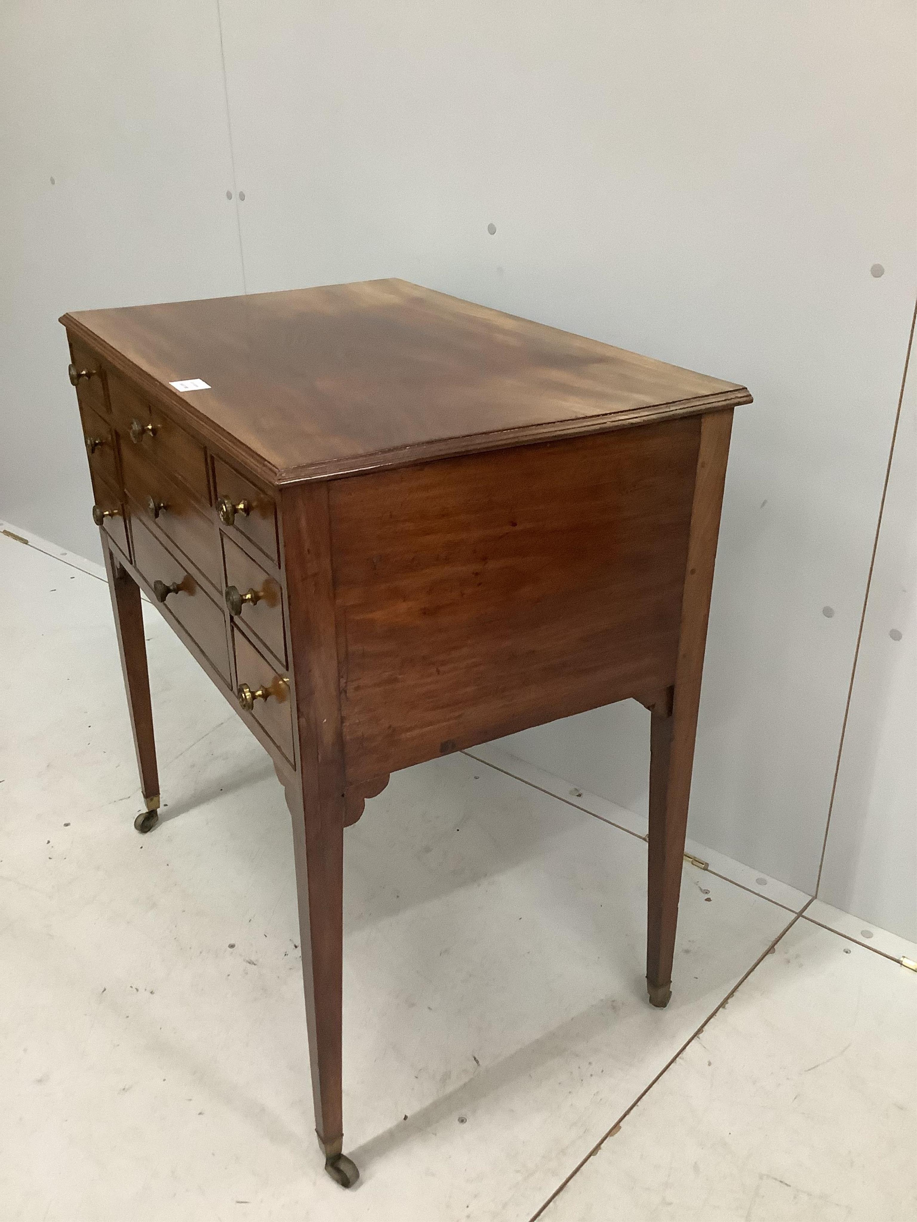 A late George III mahogany enclosed dressing table, with a lift up top, over drawers, width 78cm, depth 50cm, height 83cm. Condition - fair